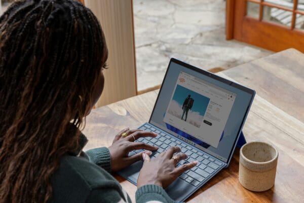 A woman typing on a laptop