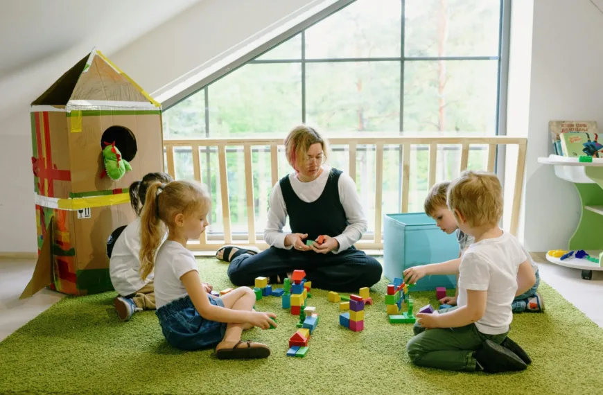 Children playing with teacher in classroom