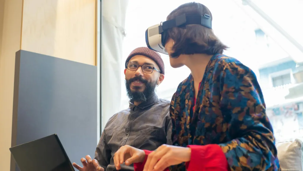 a man and woman looking at a computer screen