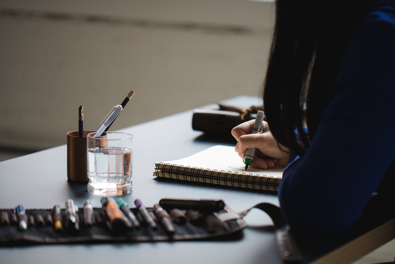 a person writing on a notebook